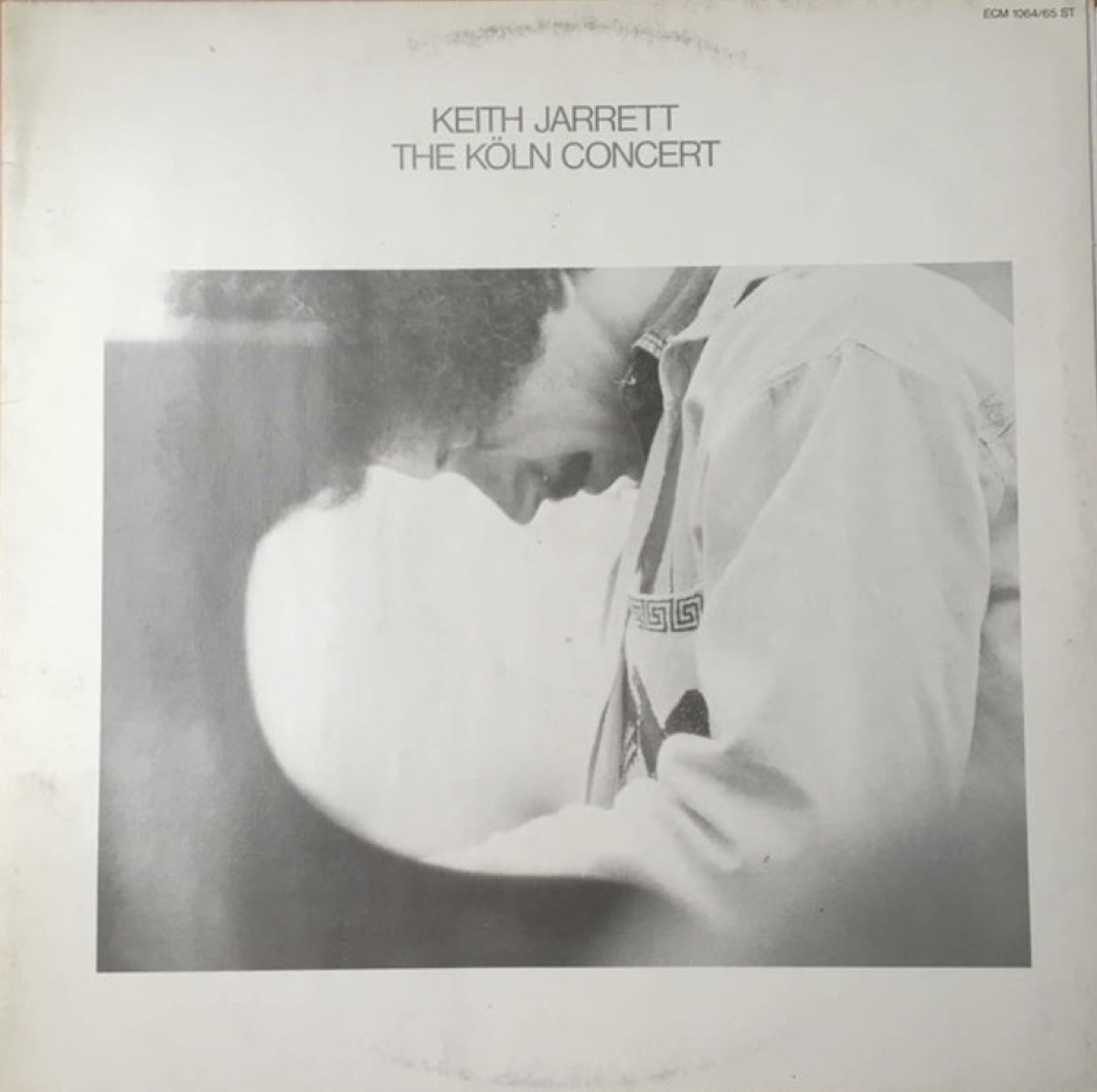 Cover of Keith Jarrett’s The Köln Concert: a black-and-white photograph of Jarrett bent low over the keyboard, eyes down, in a white shirt